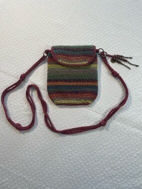 The SAK 
hand-crocheted crossbody bag with charm & long braided body strap